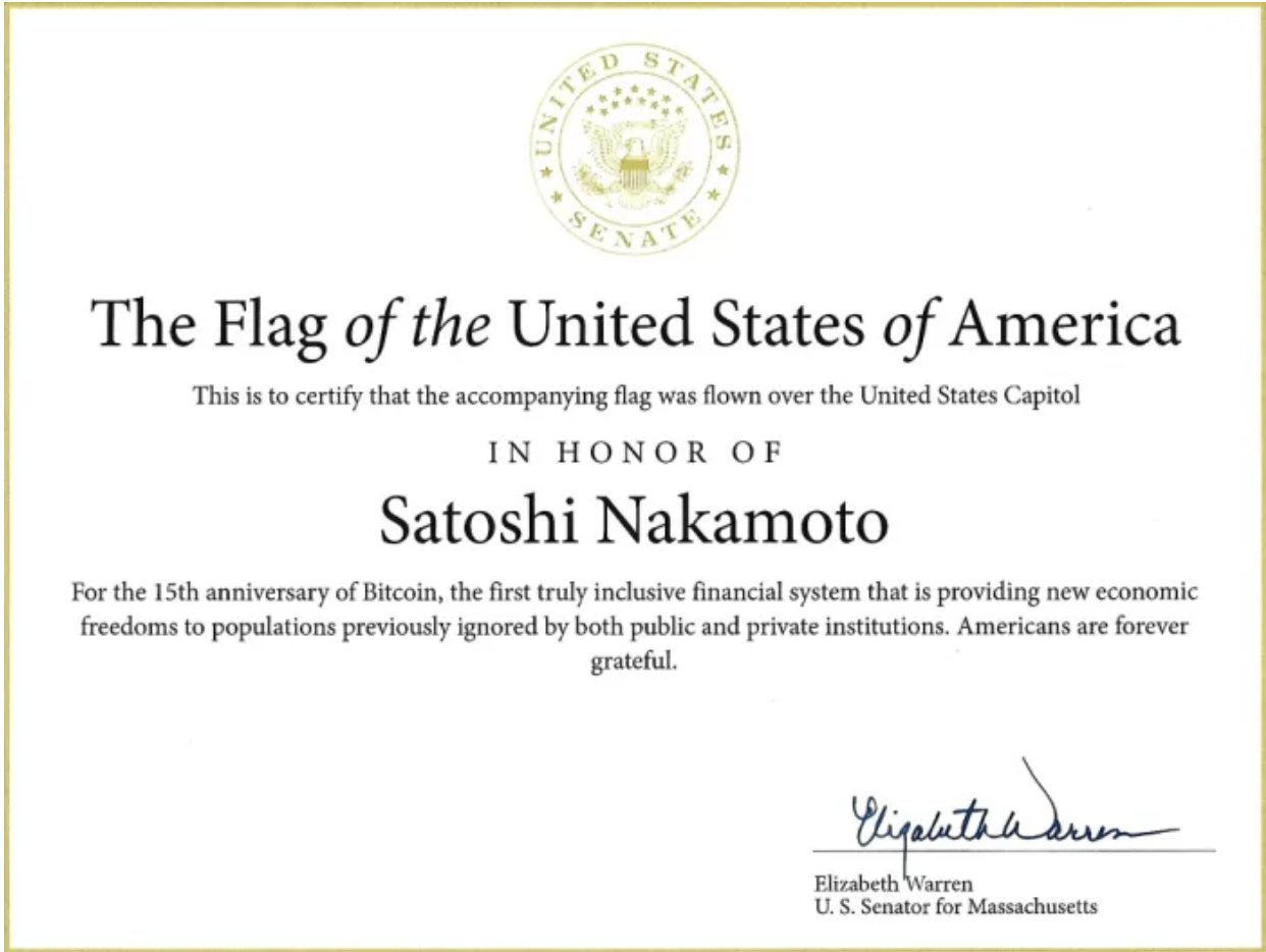 A photo of the Bitcoin event: Elizabeth Warren Signs A Certificate To Honour Satoshi Nakamoto With A Ceremonial Flag Flying